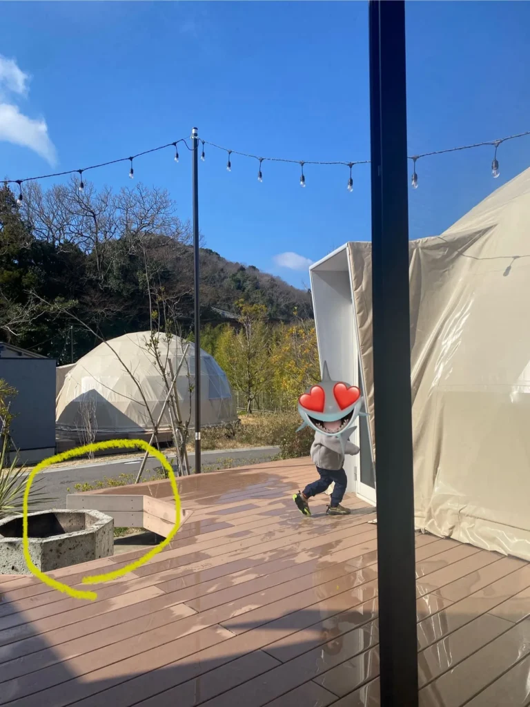 ドームテントの外にあるウッドデッキの真ん中にあるキャンプファイヤー用のファイヤーピッド