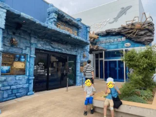 大きなタカアシガニの模型が看板に貼り付けられたシーラカンス・ミュージアムの入り口全体像を10メートル離れたところから撮影した写真